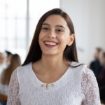 Women in dress in white and smiles